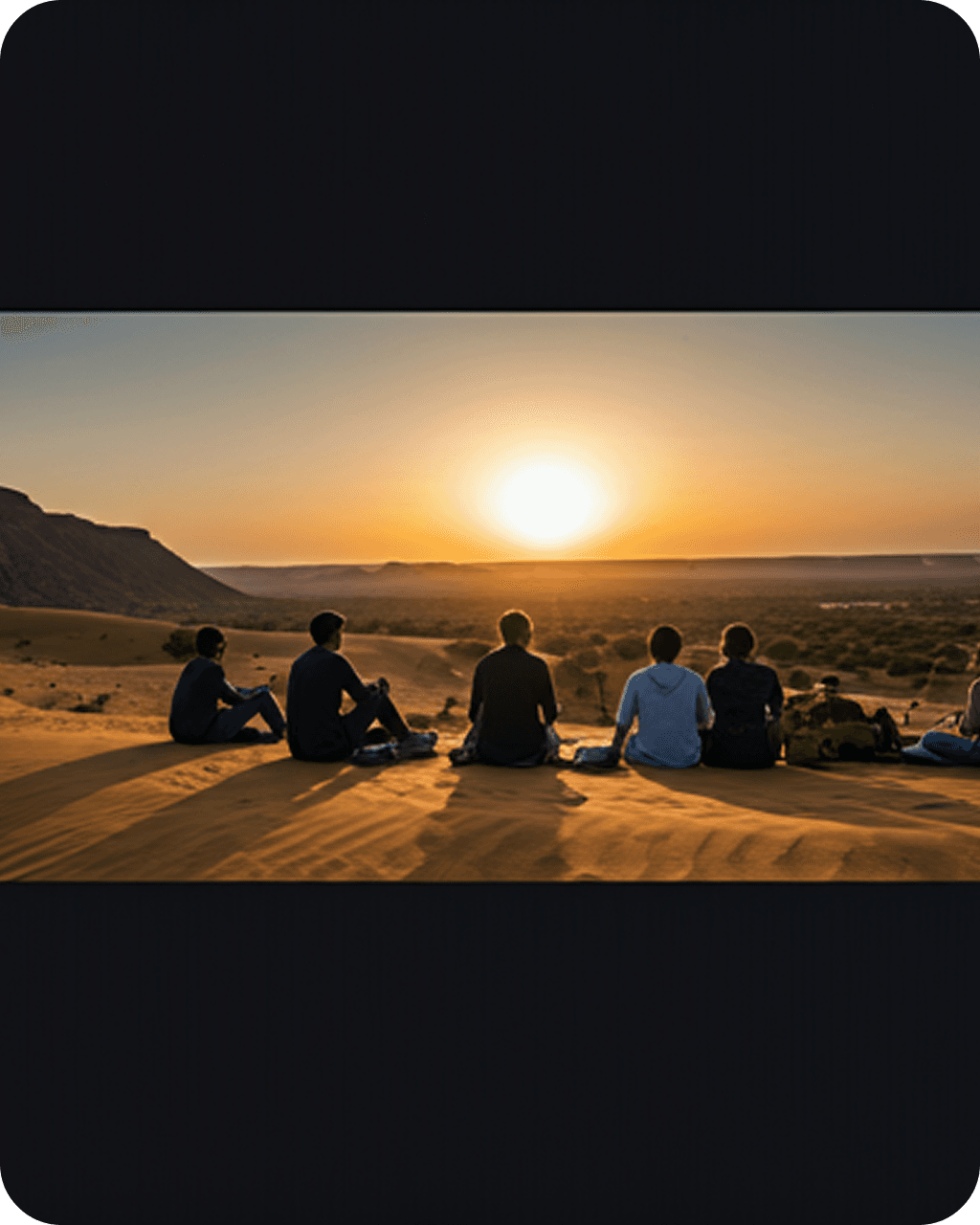 Group of travelers silhouetted against golden desert sunset