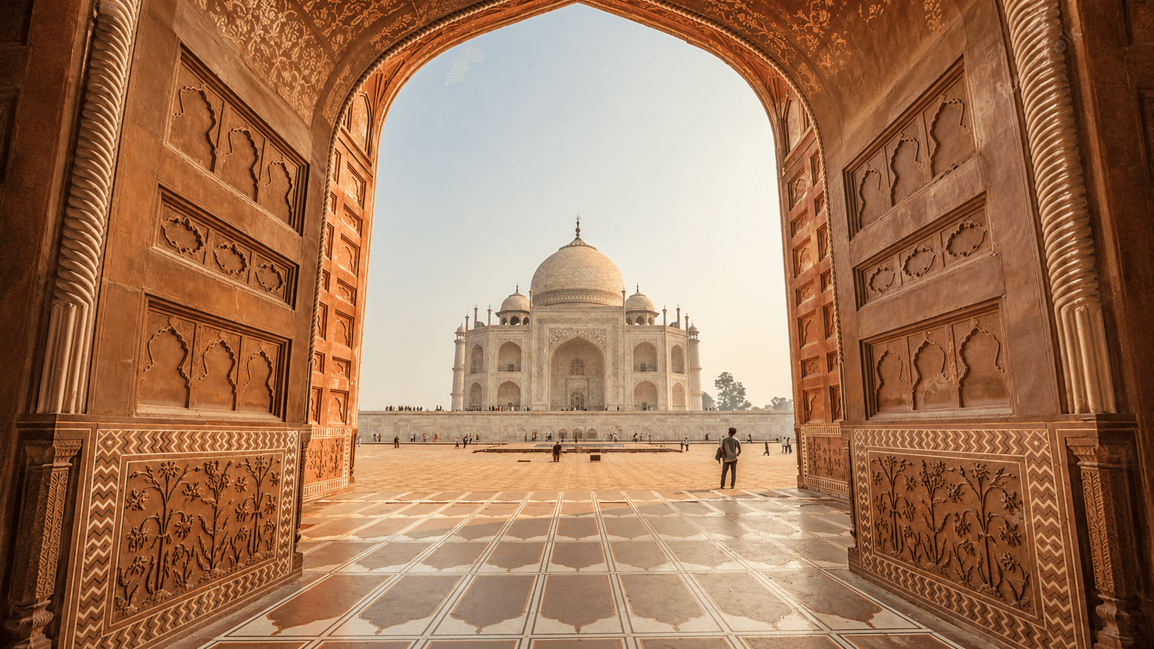 Taj Mahal framed through a grand archway